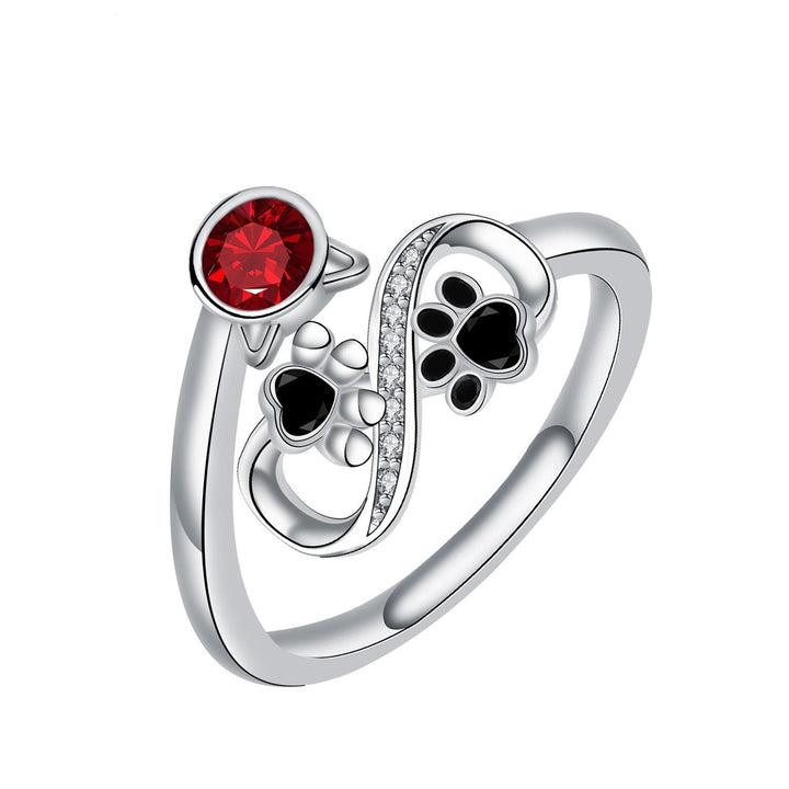 Adjustable ring with black paw print and red gemstone
